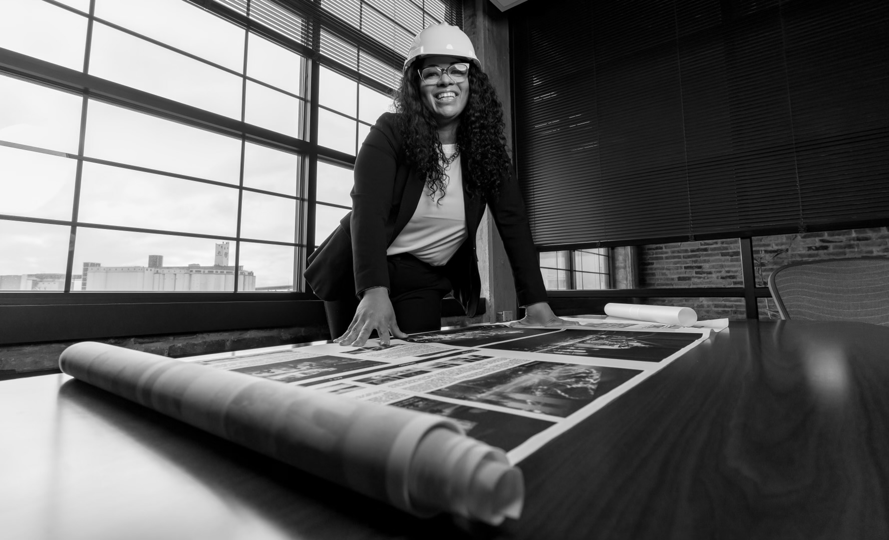 Geraldine Ford, MBA, Certified MWBE, reviewing project plans